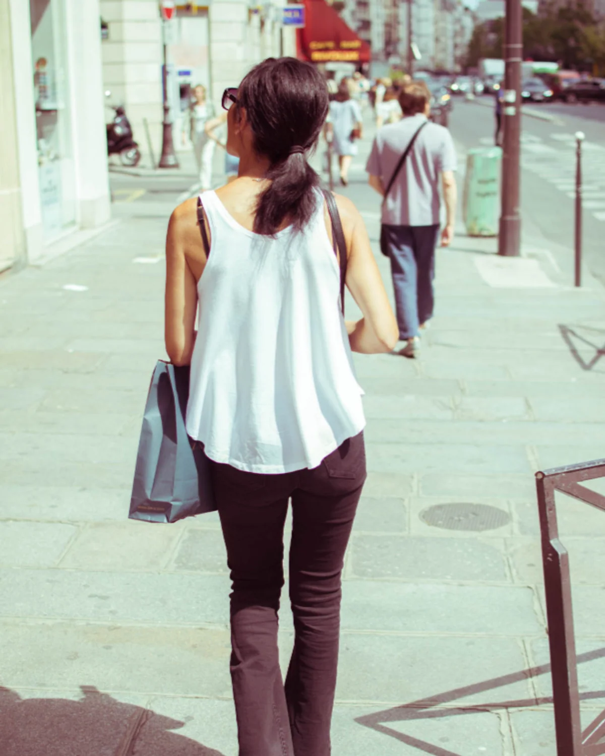 Woman carrying a large tote bag while traveling