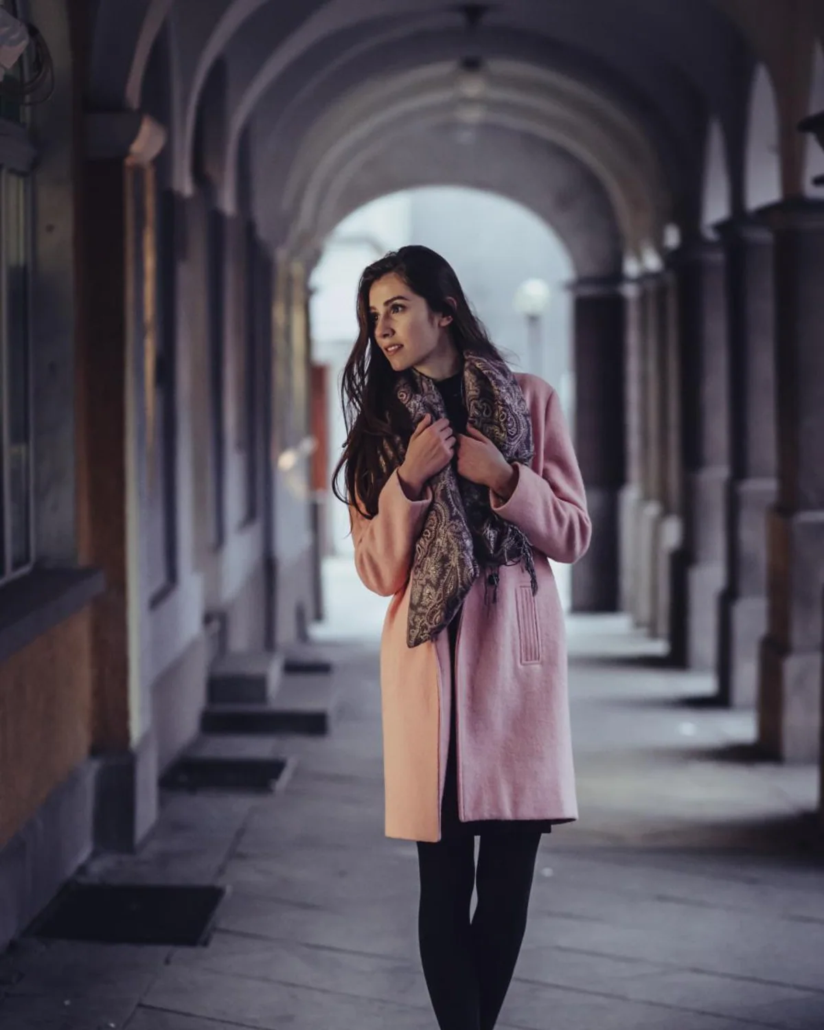Woman adding a scarf to a seasonal outfit